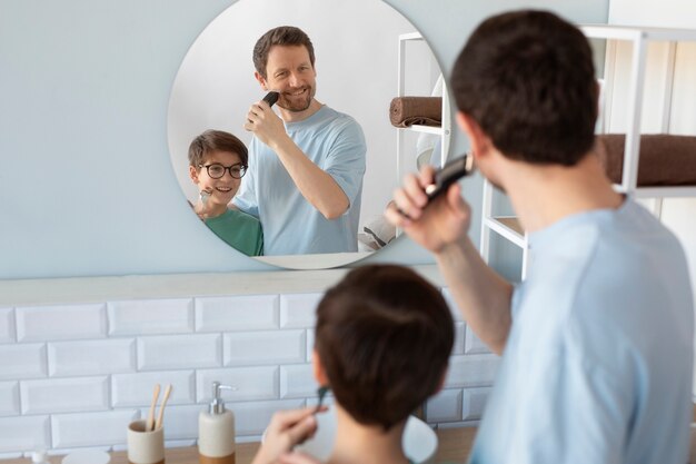 Back view father and son shaving