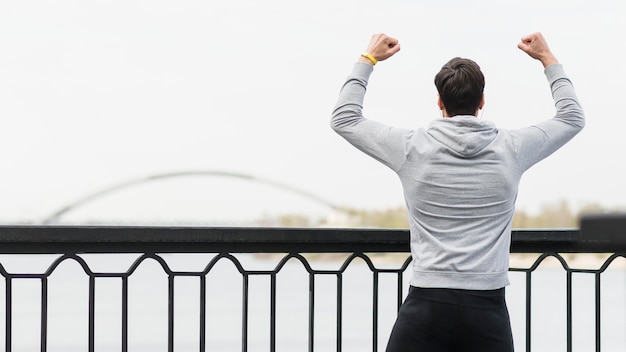 Back view fit athlete celebrating outdoors