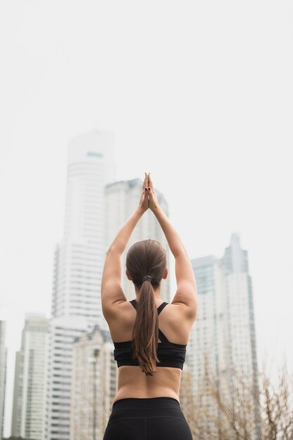 Back view fit girl with arms up