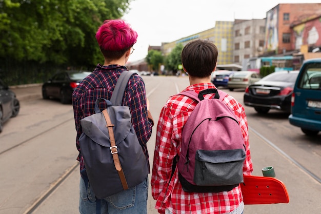 Free photo back view friends wearing backpacks