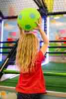 Free photo back view of girl holding ball