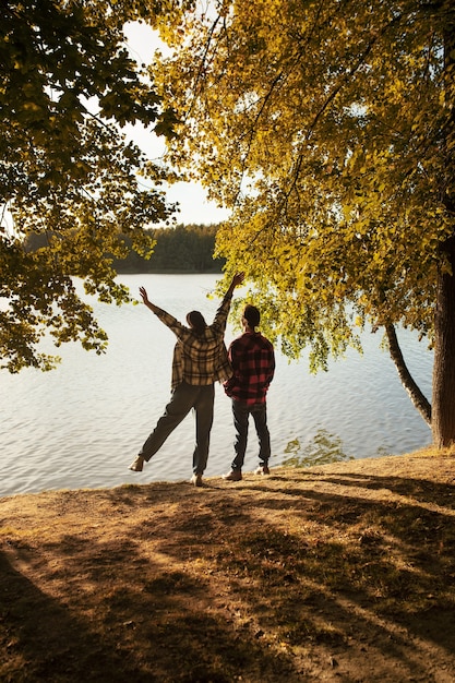 Free photo back view happy couple in nature