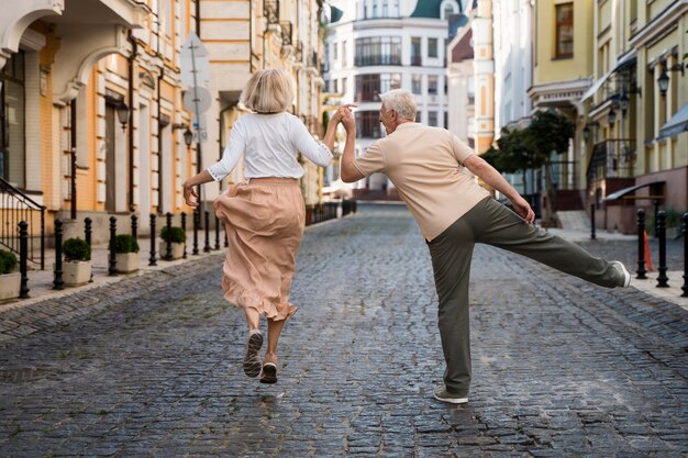 Back view of happy older couple in the city