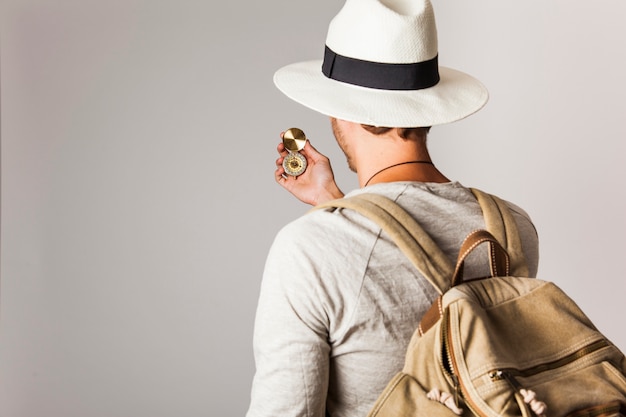 Back view of hipster style tourist with compass