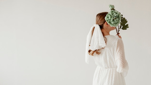 Back view lady holding flower