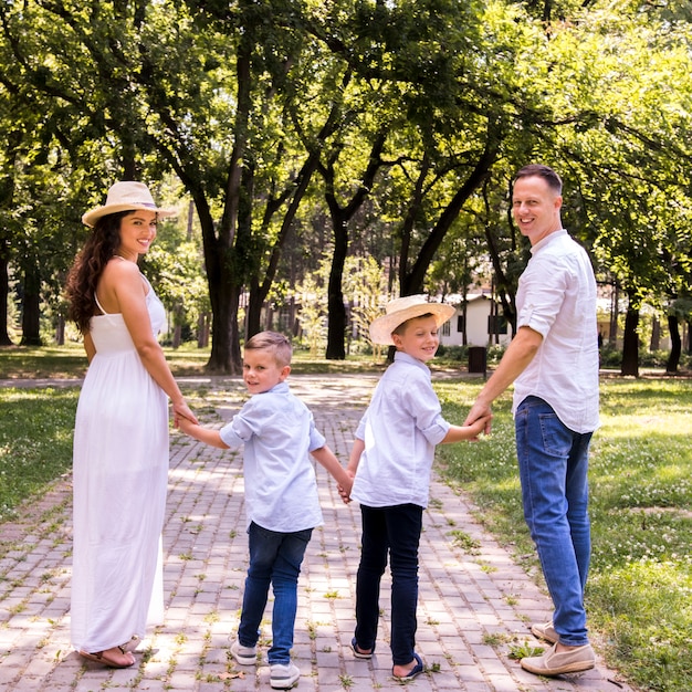 Free photo back view lovely family looking at the camera