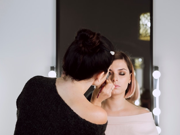 Back view of make-up artist working