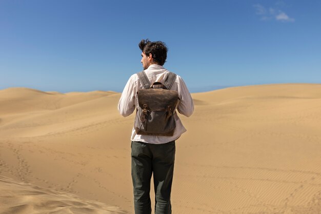 Back view man carrying backpack