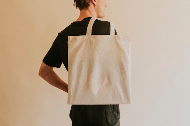 Back view man carrying tote bag