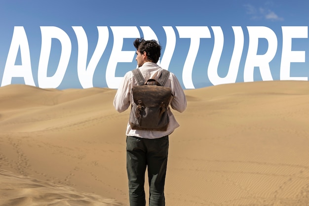 Free photo back view man in desert with wavy texts