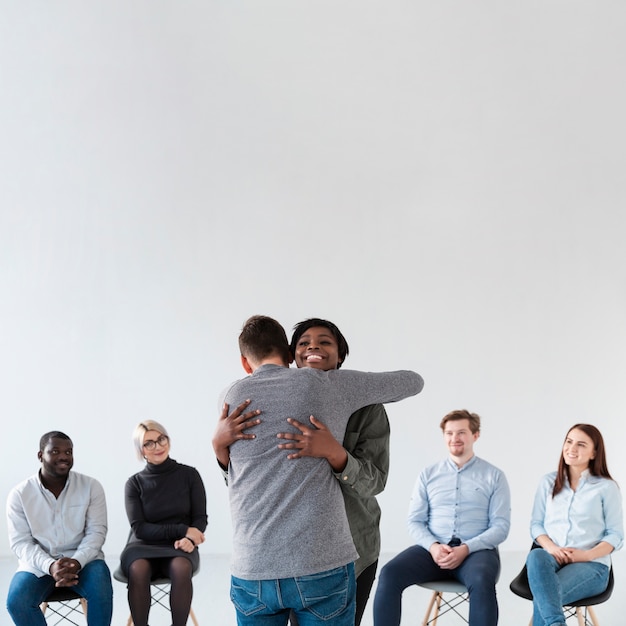 Free photo back view man embracing smiling woman