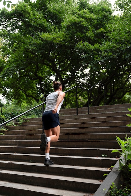 Back view of man running up the stairs