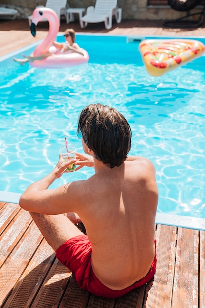 Back view man staring at the pool