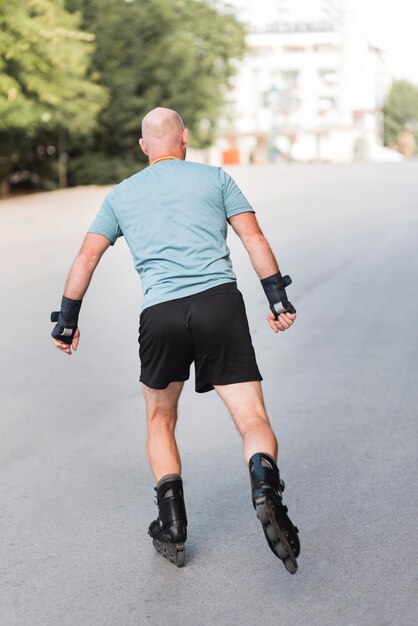 Back view man wearing roller blades