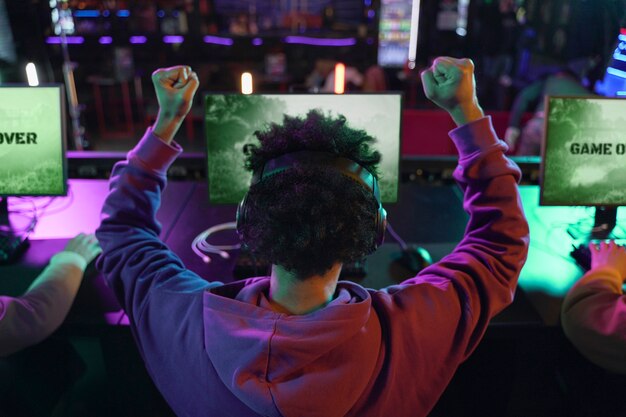 back view man winning at videogame