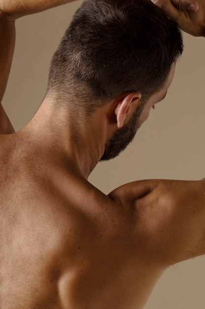 Foto gratuita uomo di vista posteriore con la posa della barba