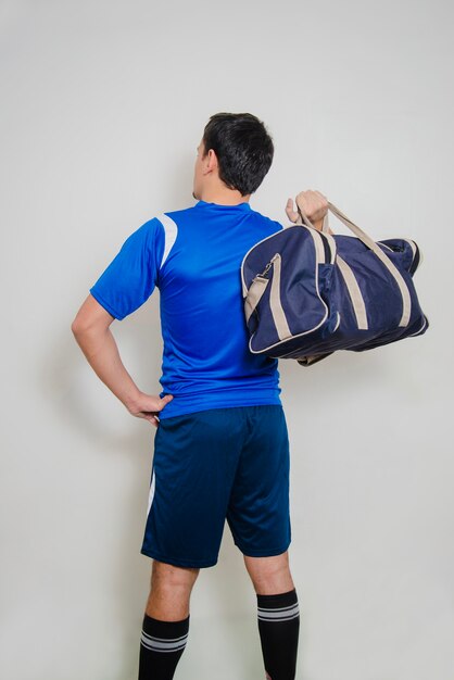 Back view of man with sports bag