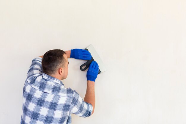 Back view of man with trowel and copy space