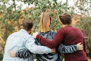 Free photo back view of men and woman embracing