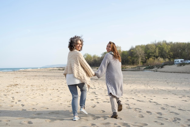 Back view of mother and daughter at the beach