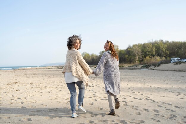 back view of mother and daughter at the beach