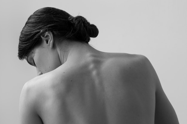 Black And White Image Of Nude Woman From Behind Holding A Whip