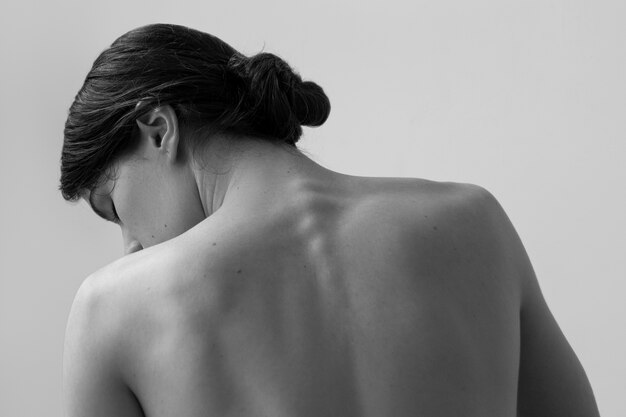 Back view nude woman posing black and white