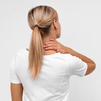back view of woman with neck pain