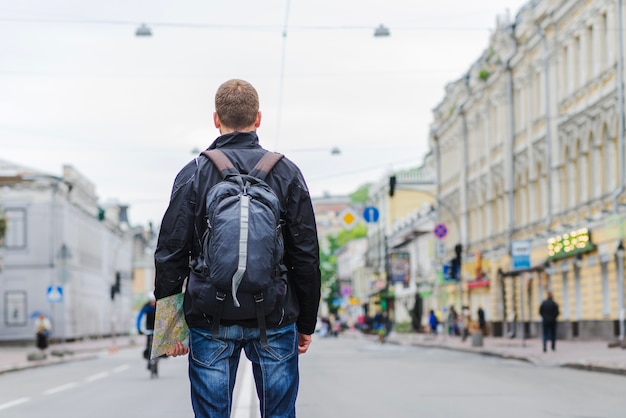 Back view om tourist with backpack