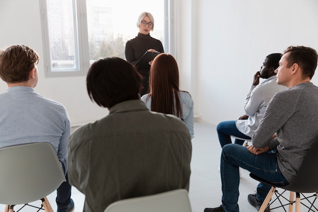 Back view patients looking at rehab doctor