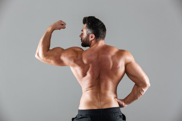 Вид сзади портрет мускулистого мужского культуриста без рубашки