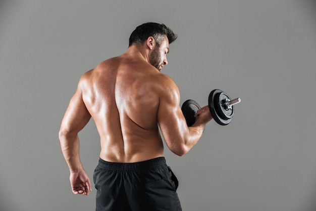 Free photo back view portrait of a muscular strong shirtless male bodybuilder