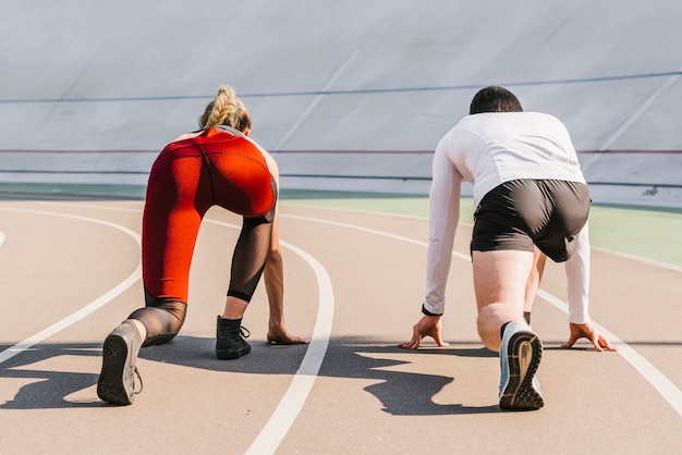 Back view of runners taking position