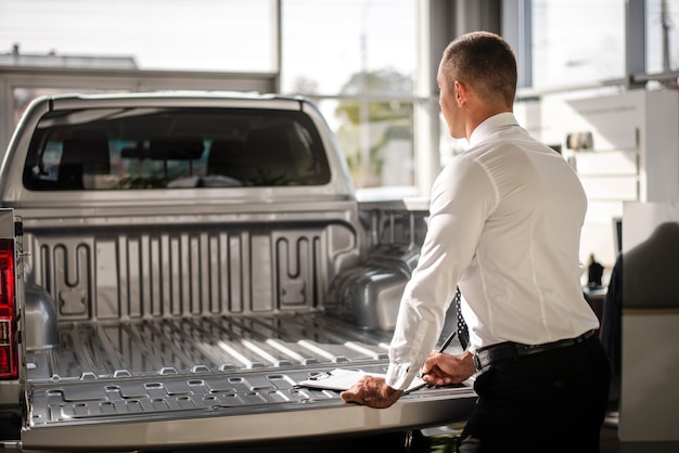 Back view salesman behind a truck