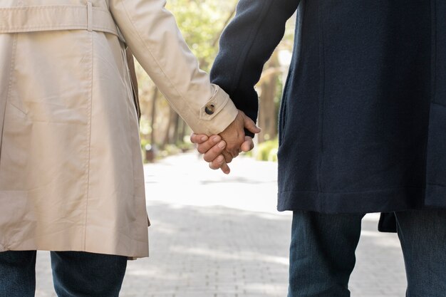 Back view senior people holding hands