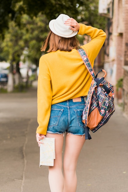 Back view of solo traveling woman