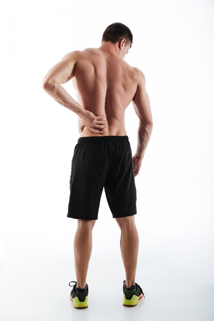 Back view of sportsman have a painful feelings in body.