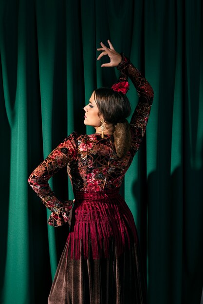 Back view stunning flamenca dancer raising hand