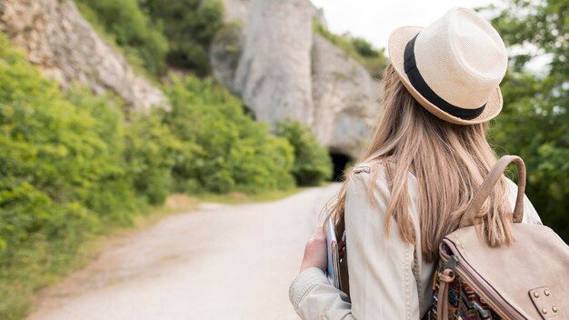 Back view stylish traveller with hat