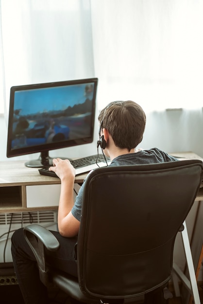 Back view teenage boy playing a game