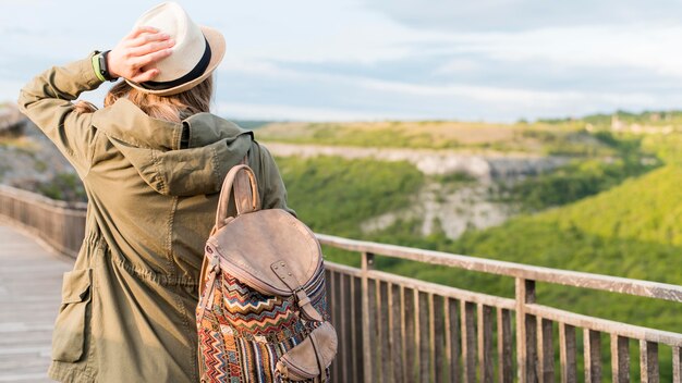 帽子とバックパックの背面図旅行者