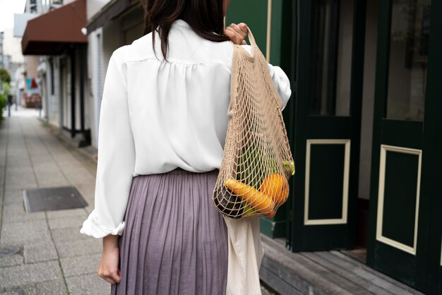 Back view woman carrying tote bag