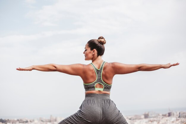 Back view of woman doing balance exercise