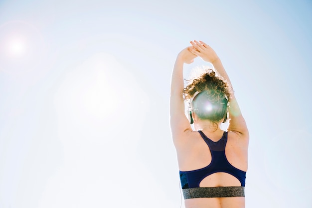 Free photo back view woman exercising in nature