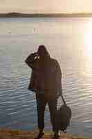 Free photo back view woman holding backpack