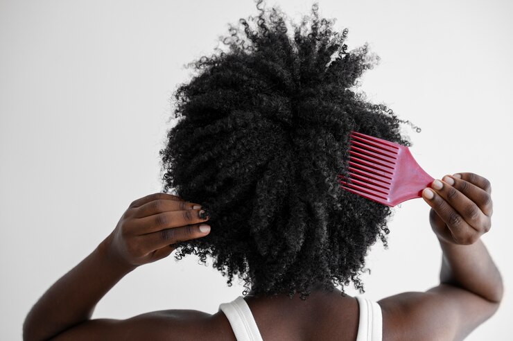 Free Photo back view woman holding pink brush