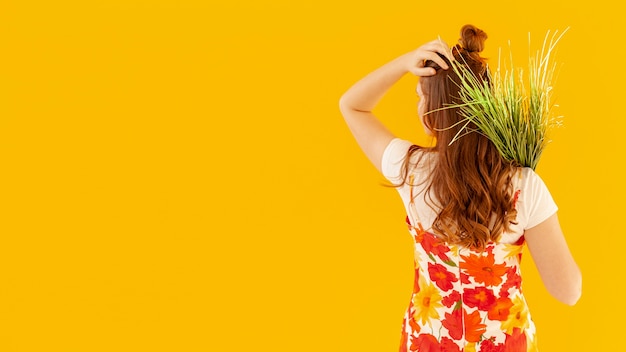 Back view woman holding plants