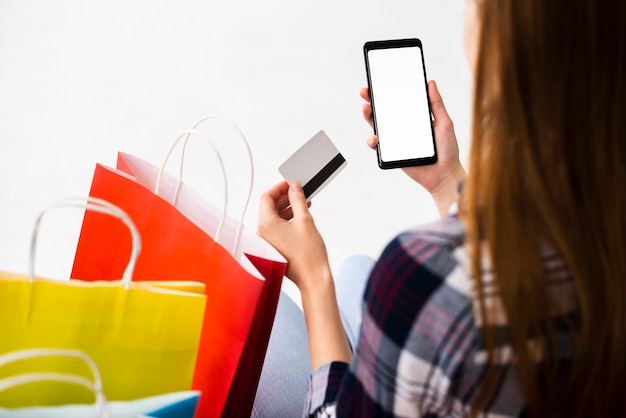 Free photo back view woman looking checking phone mock-up