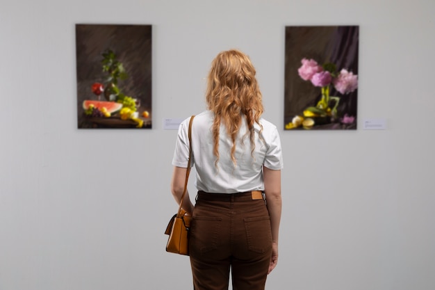 Back view woman looking at painting