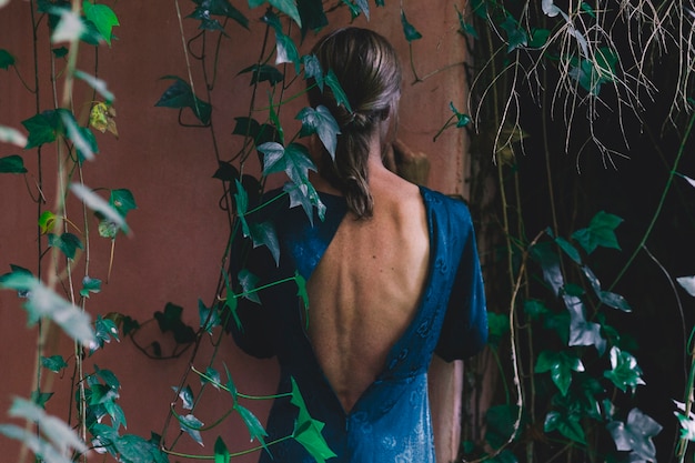 Back view woman near old building